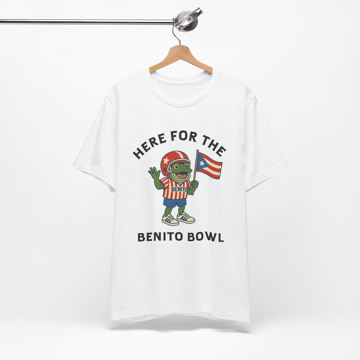 White t-shirt with Puerto Rico inspired coqui sapo concho toad holding Puerto Rican flag and 'Here for the Benito Bowl' text on a hanger